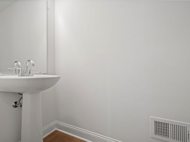 bathroom with wood-type flooring