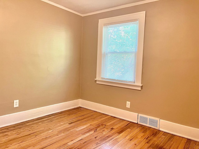 spare room with crown molding and light hardwood / wood-style floors