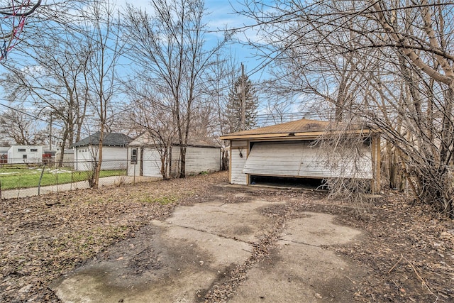 view of home's exterior with a garage and an outdoor structure