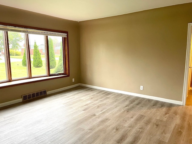 spare room featuring light wood-type flooring