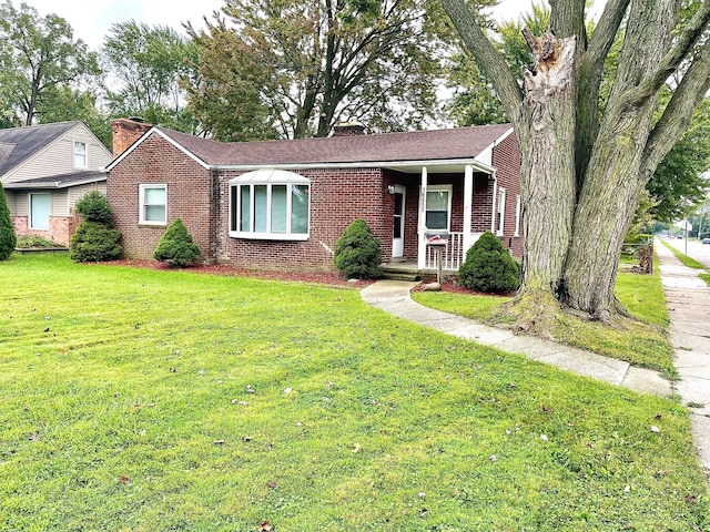 view of front of home featuring covered porch and a front yard