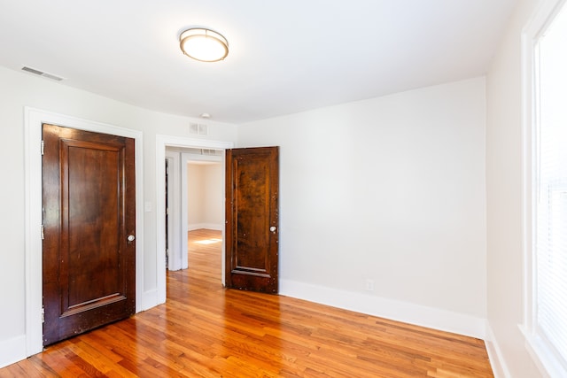 unfurnished bedroom with hardwood / wood-style flooring