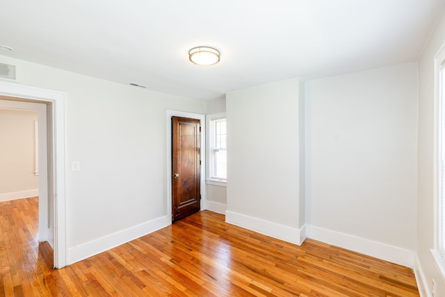 spare room with light wood-type flooring