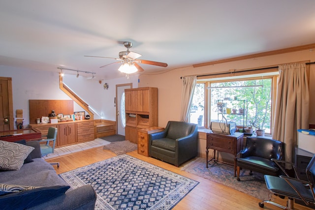 living room featuring light hardwood / wood-style flooring and ceiling fan