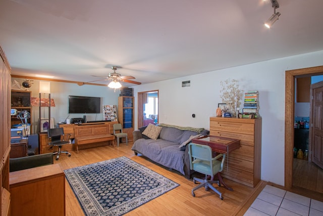 living room featuring hardwood / wood-style floors and ceiling fan