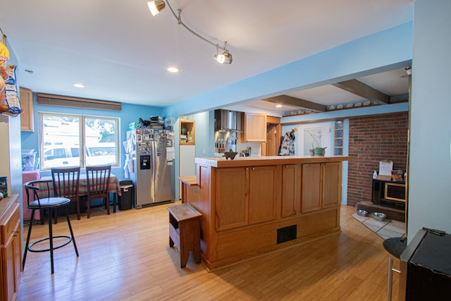 39357 Cheshire St, Westland, MI 48186 - kitchen with stainless steel fridge, light wood-type flooring, wall chimney range hood, light countertops, and beamed ceiling