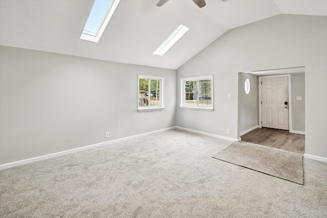 interior space with ceiling fan, high vaulted ceiling, and light carpet