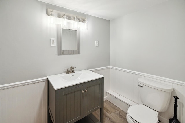 bathroom featuring wood-type flooring, vanity, and toilet