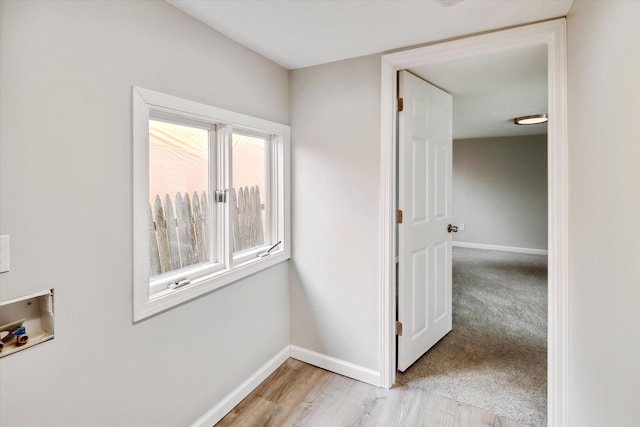 hall with light hardwood / wood-style flooring