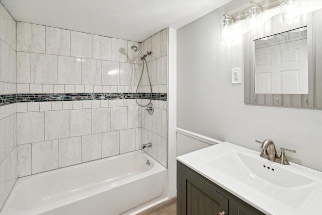 bathroom featuring vanity, hardwood / wood-style flooring, and tiled shower / bath