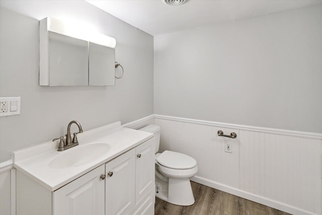 bathroom featuring hardwood / wood-style flooring, vanity, and toilet