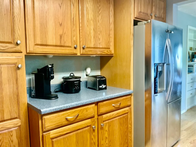 kitchen featuring stainless steel fridge and light wood-type flooring