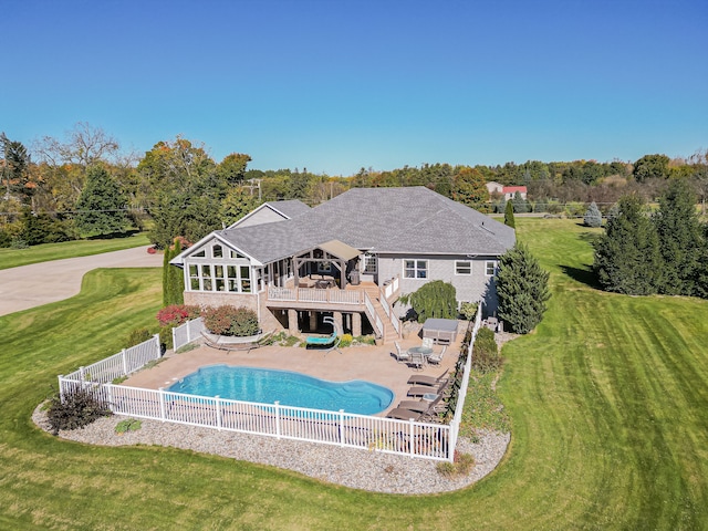 view of pool featuring a patio area, a yard, and a wooden deck