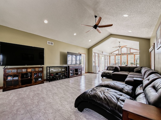 living room with ceiling fan, a healthy amount of sunlight, a textured ceiling, and vaulted ceiling