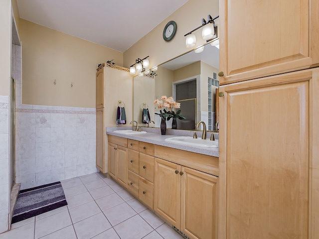 bathroom with tile patterned flooring, vanity, and tile walls