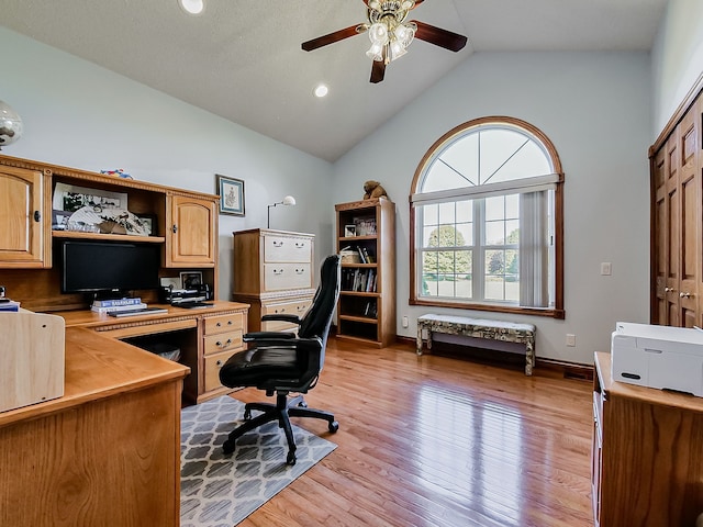 office featuring ceiling fan, high vaulted ceiling, and light hardwood / wood-style flooring