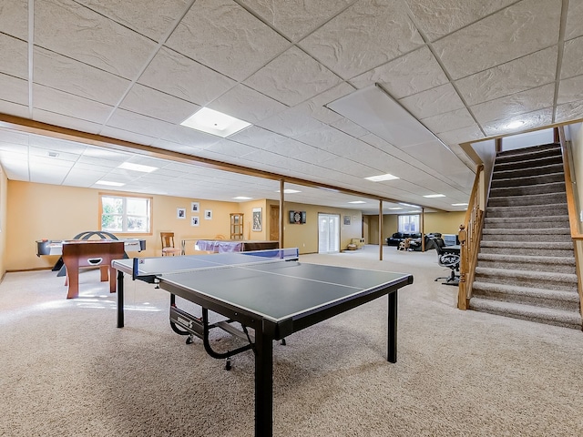 rec room with carpet and a paneled ceiling