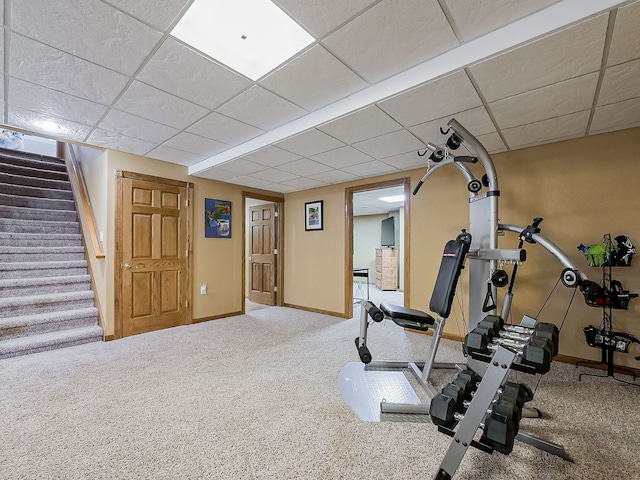 workout room with carpet flooring and a paneled ceiling