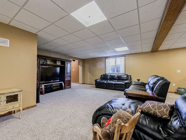 carpeted living room with a drop ceiling