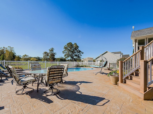 view of patio with a fenced in pool