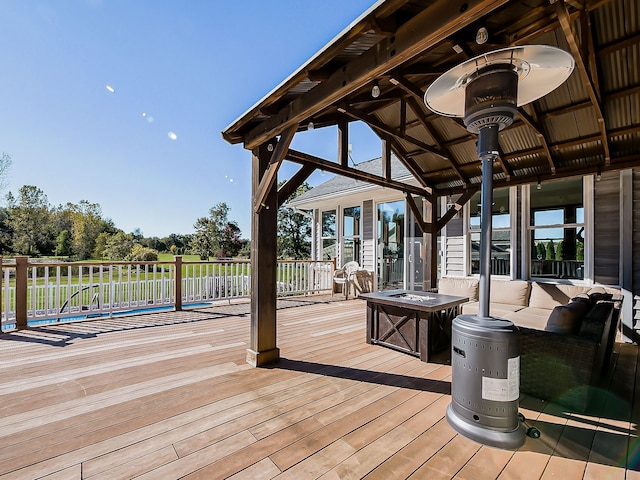 wooden terrace featuring a fire pit and a gazebo