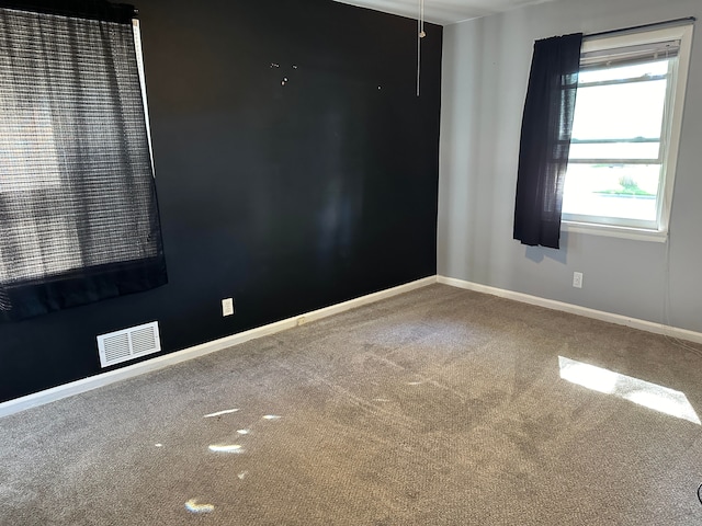 unfurnished room featuring carpet