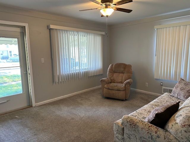 living area with carpet flooring and ceiling fan