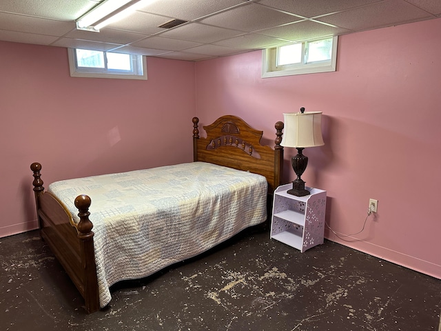 bedroom featuring a paneled ceiling and multiple windows