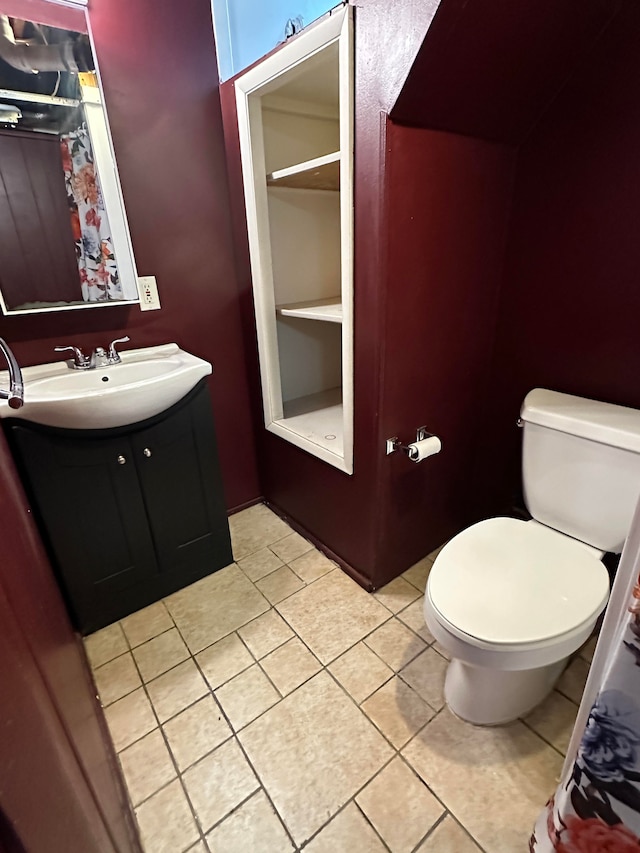 bathroom featuring tile patterned flooring, vanity, and toilet