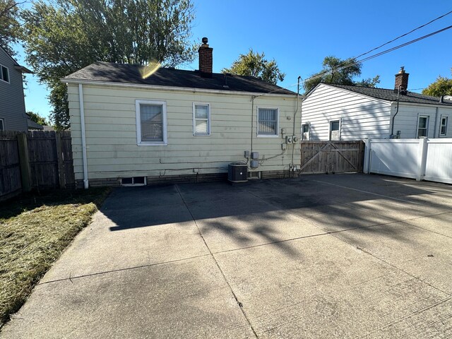 13676 Oakdale St, Southgate, MI 48195 - rear view of house featuring a chimney, a gate, and a patio area