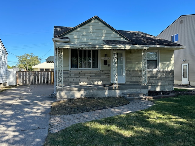 bungalow featuring a porch and a front yard