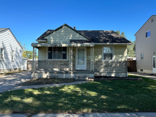 bungalow-style house with covered porch and a front lawn