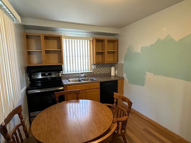 kitchen with dishwasher, electric stove, sink, hardwood / wood-style flooring, and decorative backsplash