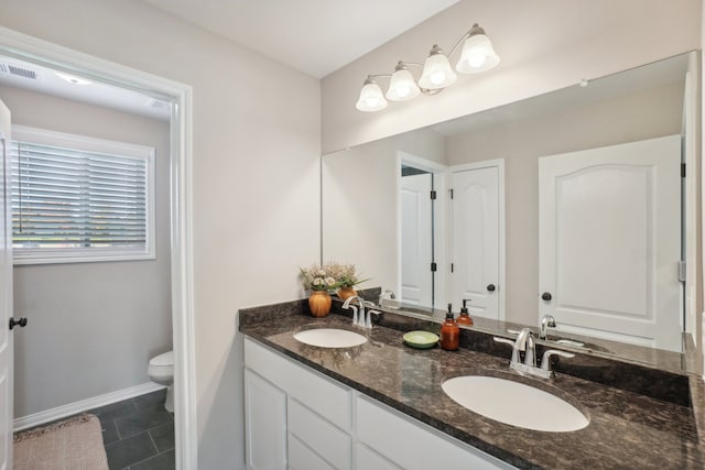 bathroom with vanity, tile patterned floors, and toilet