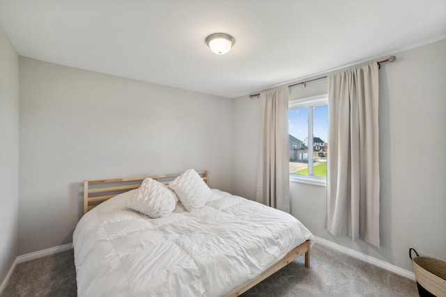 carpeted bedroom featuring baseboards