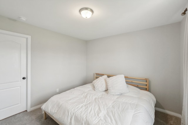 carpeted bedroom featuring baseboards