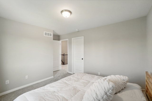 bedroom featuring visible vents, baseboards, and light colored carpet