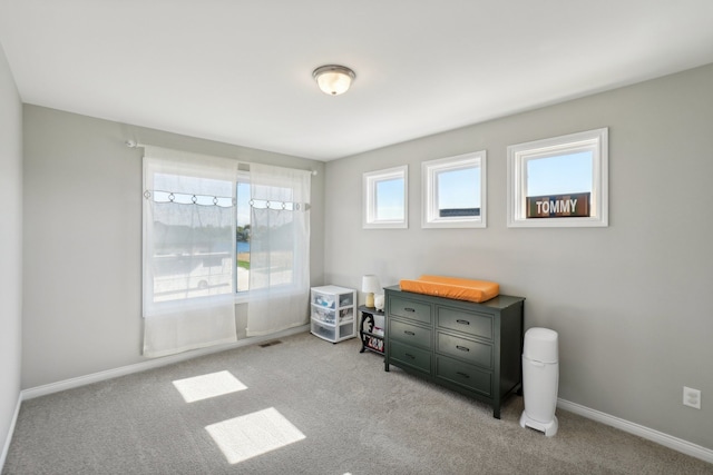 carpeted bedroom with visible vents and baseboards