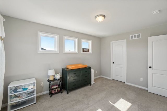 bedroom featuring light colored carpet, visible vents, and baseboards