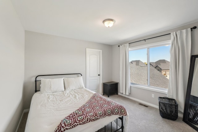 bedroom with visible vents, carpet flooring, and baseboards