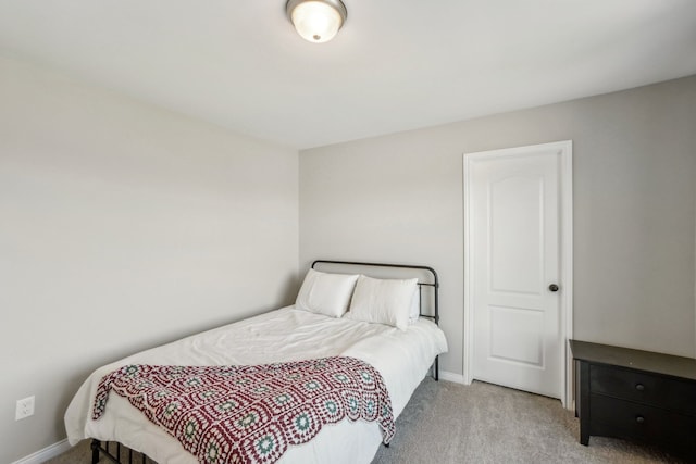 bedroom featuring baseboards and light carpet