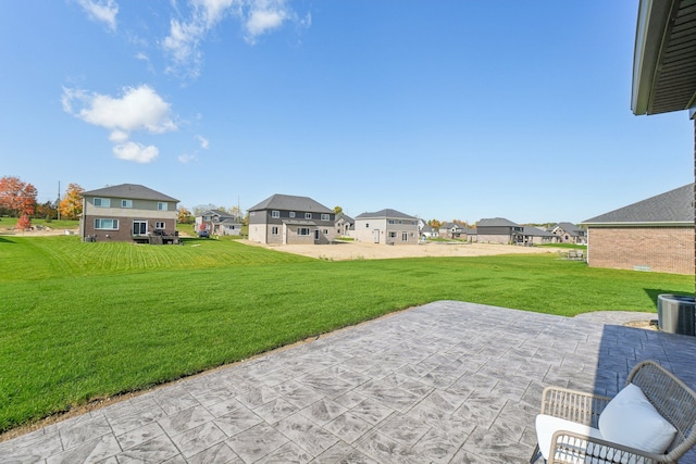 view of yard featuring central AC unit and a patio area