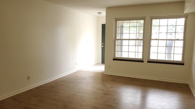 spare room featuring dark hardwood / wood-style flooring