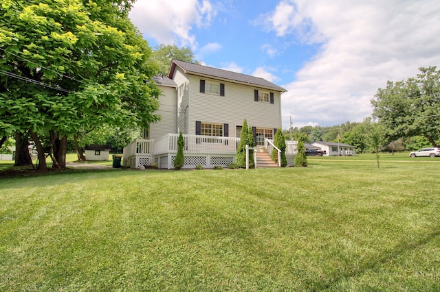 back of property with a lawn and a deck