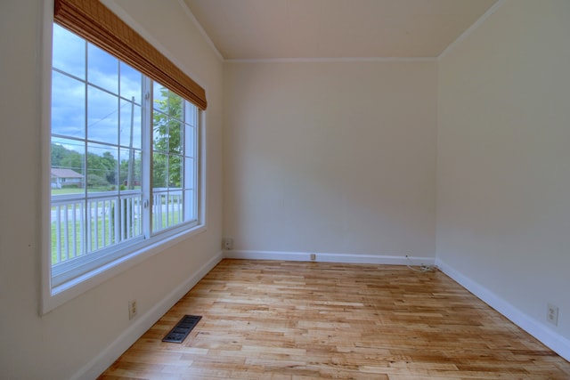 unfurnished room with crown molding and light hardwood / wood-style floors