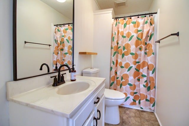 bathroom featuring vanity, toilet, a textured ceiling, and walk in shower