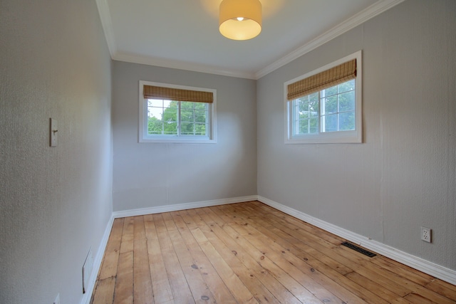 spare room with light hardwood / wood-style flooring and ornamental molding