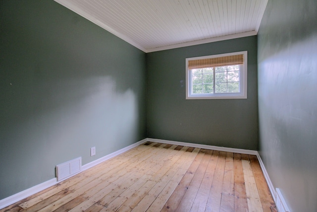 empty room with ornamental molding and light hardwood / wood-style flooring