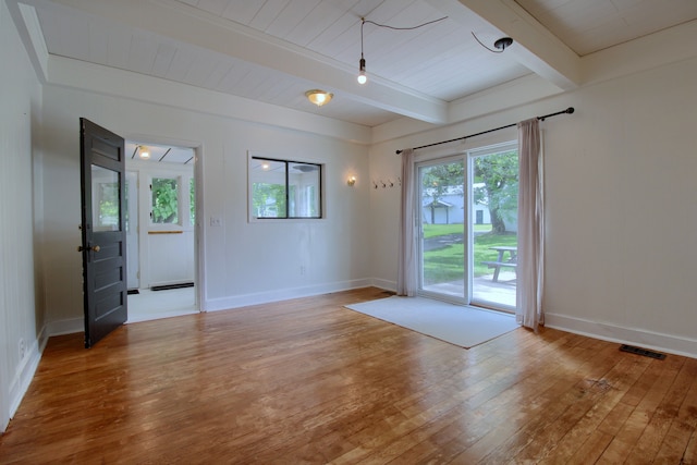 spare room featuring hardwood / wood-style floors, beamed ceiling, and wooden ceiling