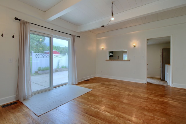 interior space featuring beamed ceiling and light hardwood / wood-style floors